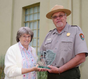 Sharon and a National Park Service Ranger holding the award